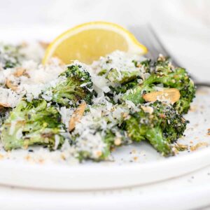 broccoli Caesar salad on plate with lemon
