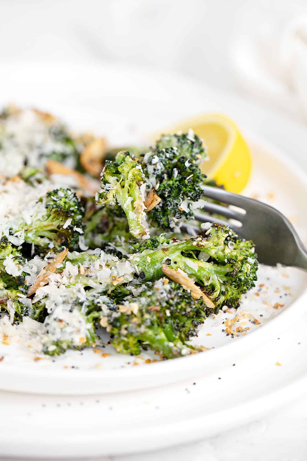 broccoli Caesar salad on plate with lemon