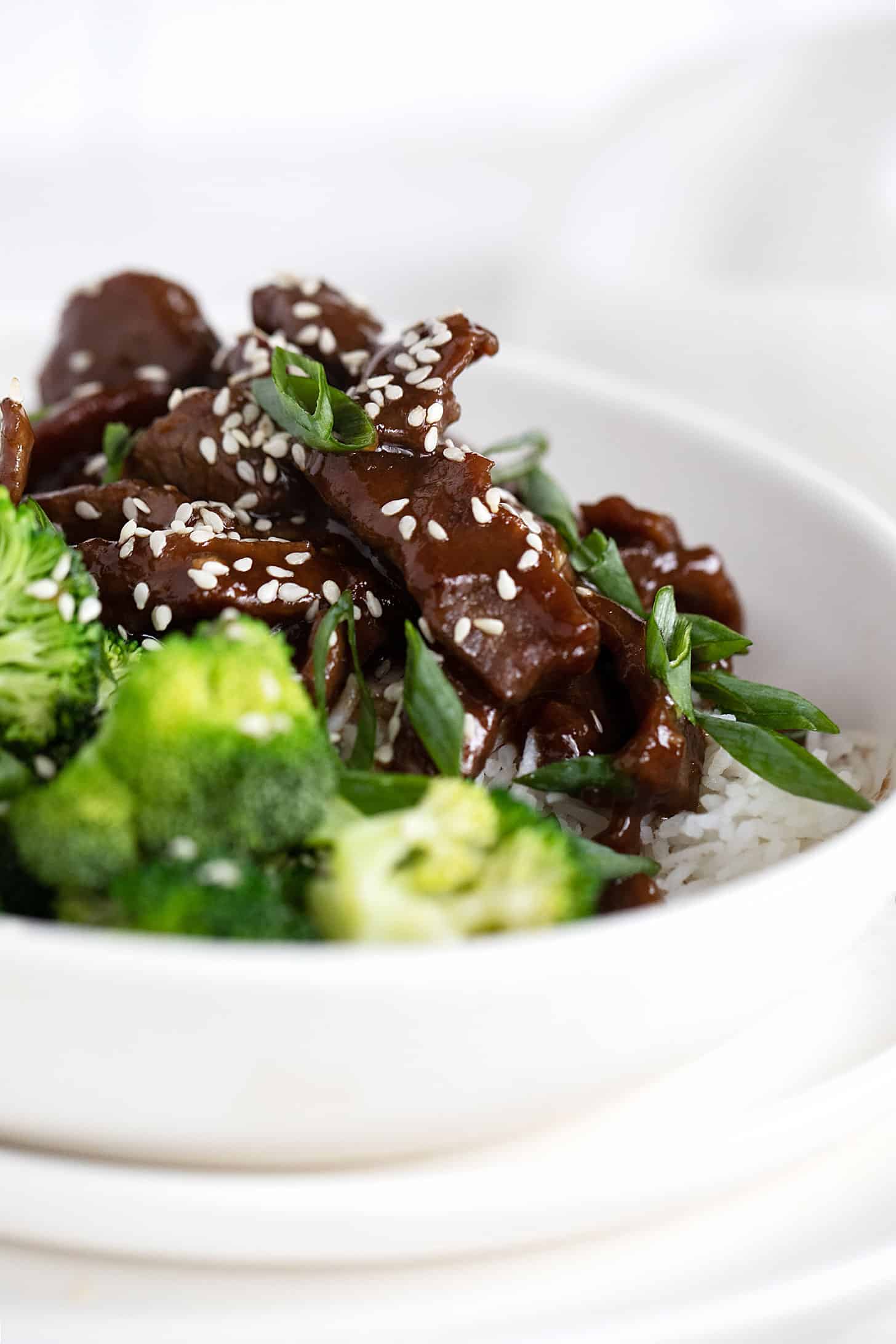 Mongolian beef with broccoli and rice in white bowl