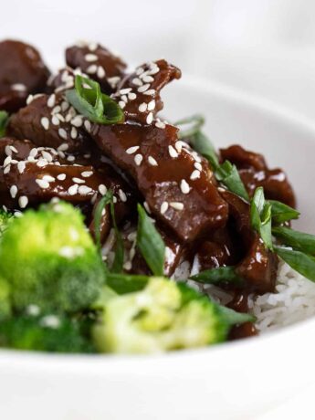 Mongolian beef with broccoli and rice in white bowl