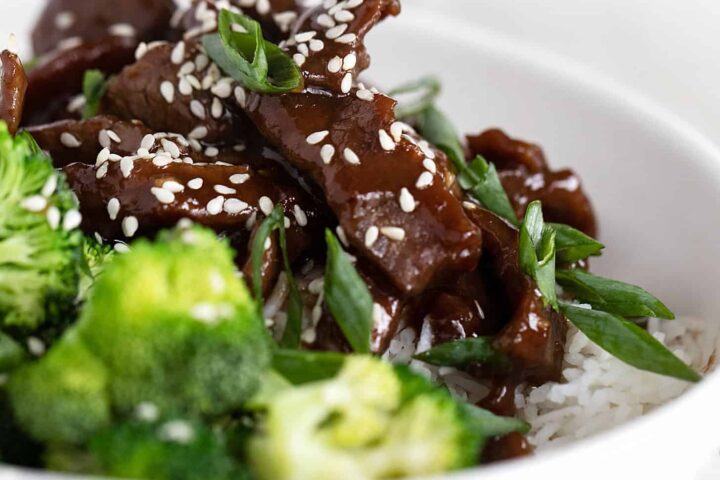 Mongolian beef with broccoli and rice in white bowl