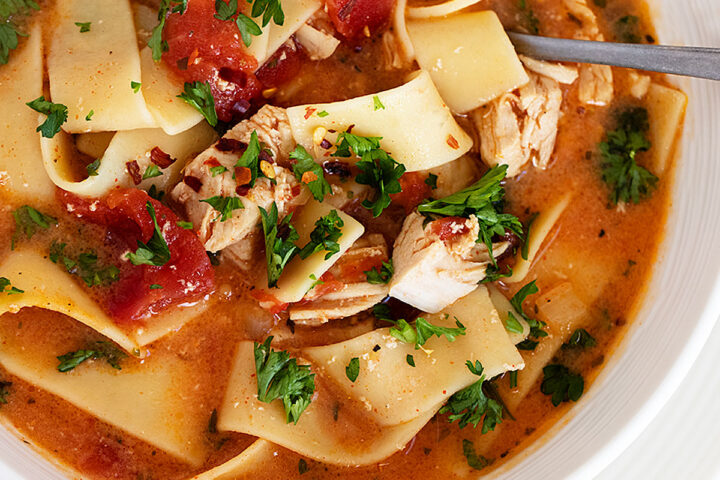 chicken paprikash soup in bowl with spoon