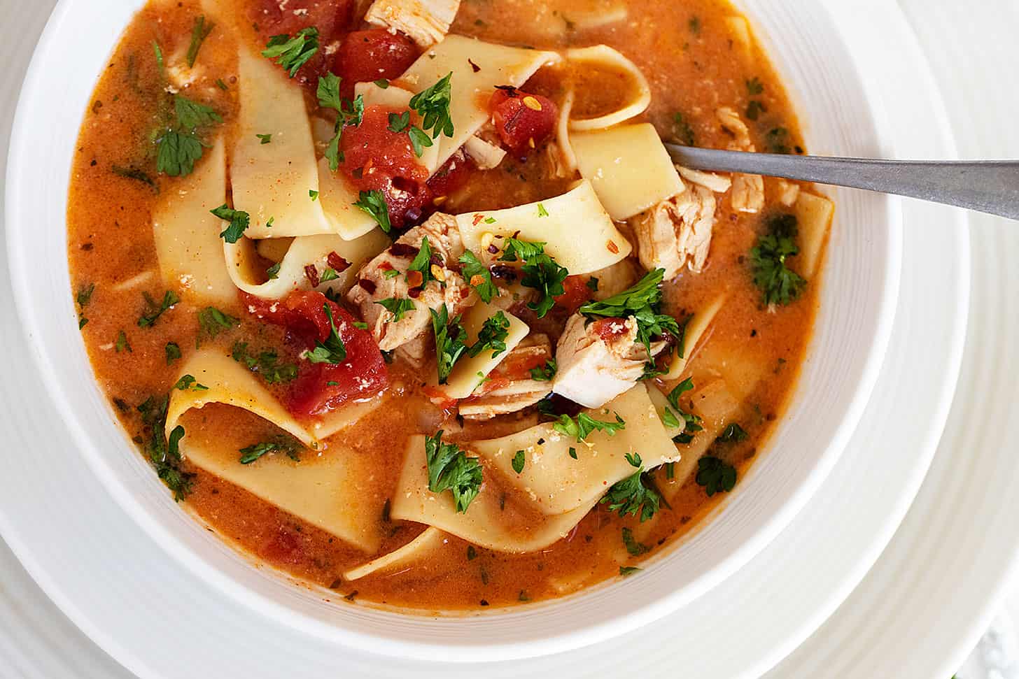 chicken paprikash soup in bowl with spoon