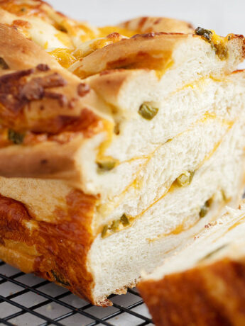 jalapeño cheese bread sliced on cooling rack.