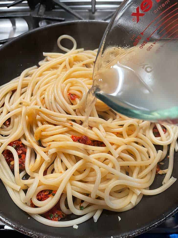 add pasta water to skillet