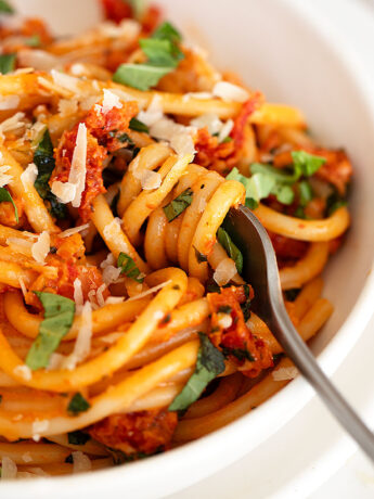 sun-dried tomato pasta in bowl with fork