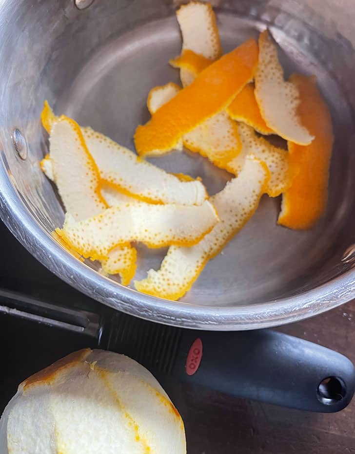 orange peel strips in saucepan