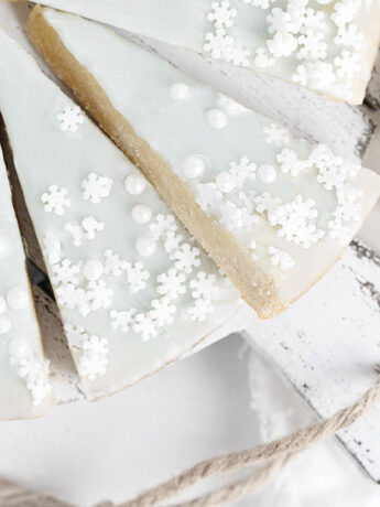 glazed sugar cookie wedges on white serving board
