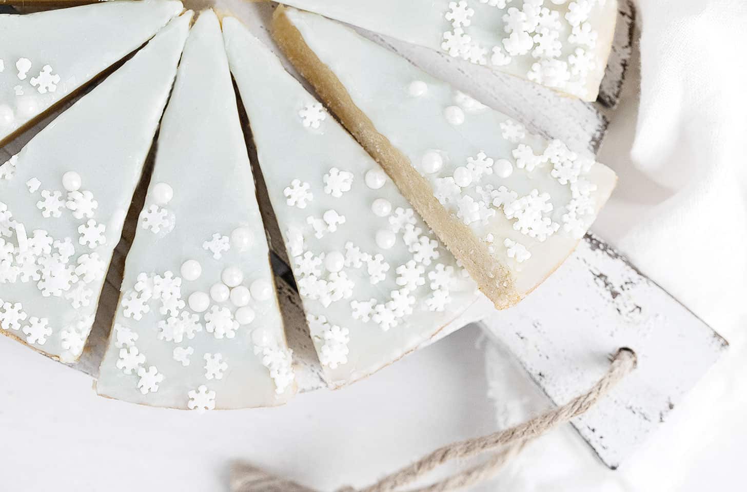 glazed sugar cookie wedges with snowflake sprinkles