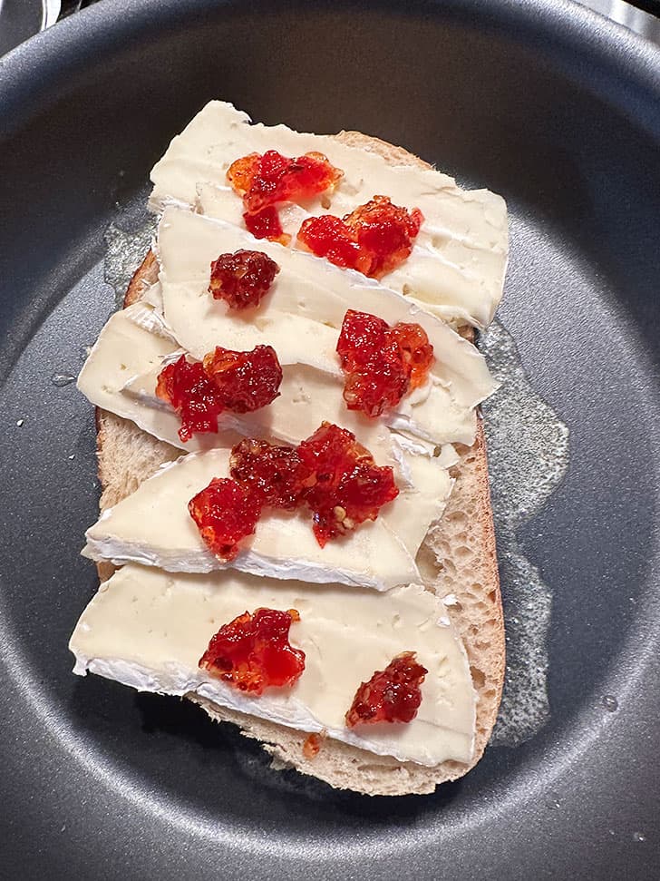 adding dollops of red pepper jelly