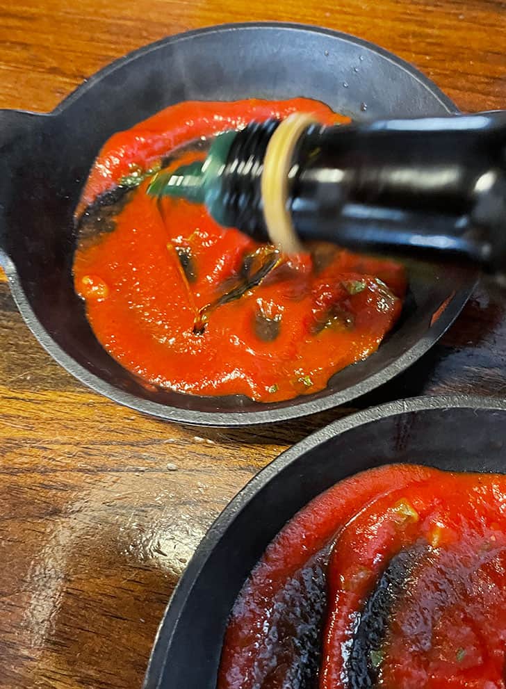 sauce added to baking dish and drizzling with olive oil
