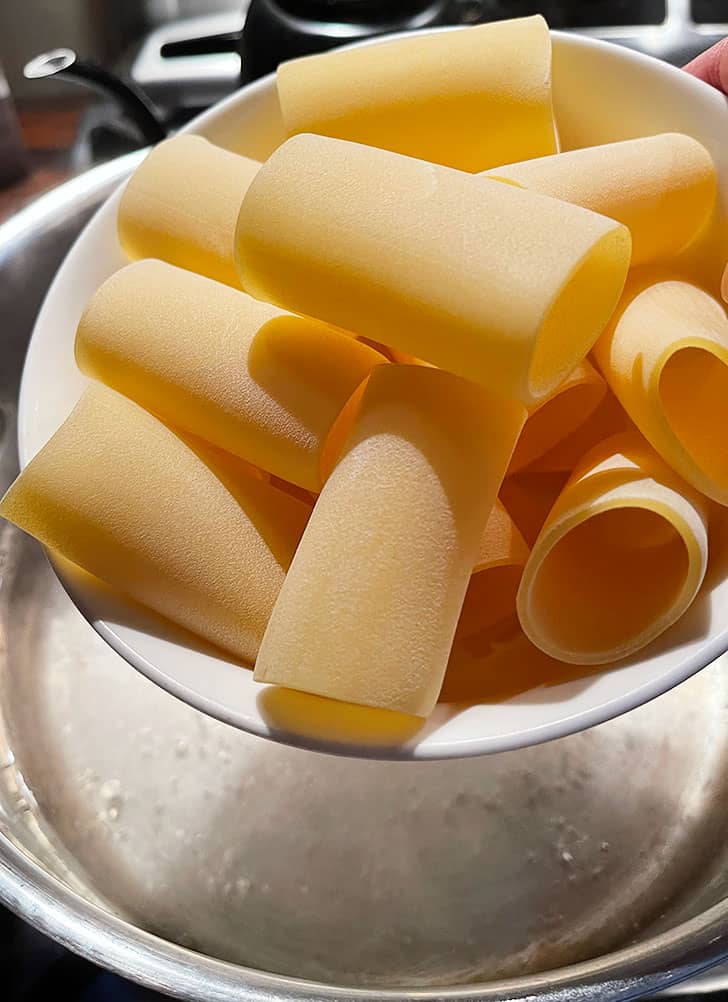 adding pasta to boiling water