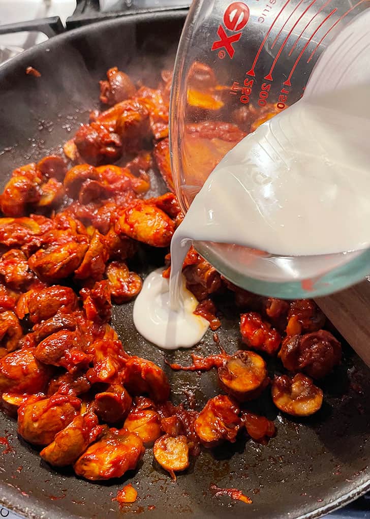adding cream to pan