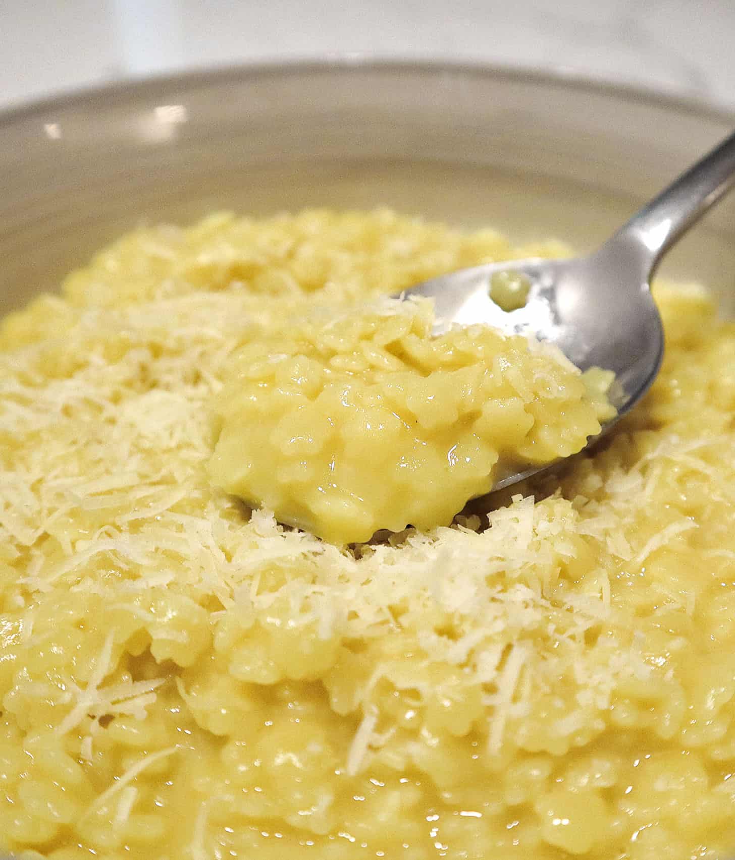 pastina with egg and cheese in bowl with spoon