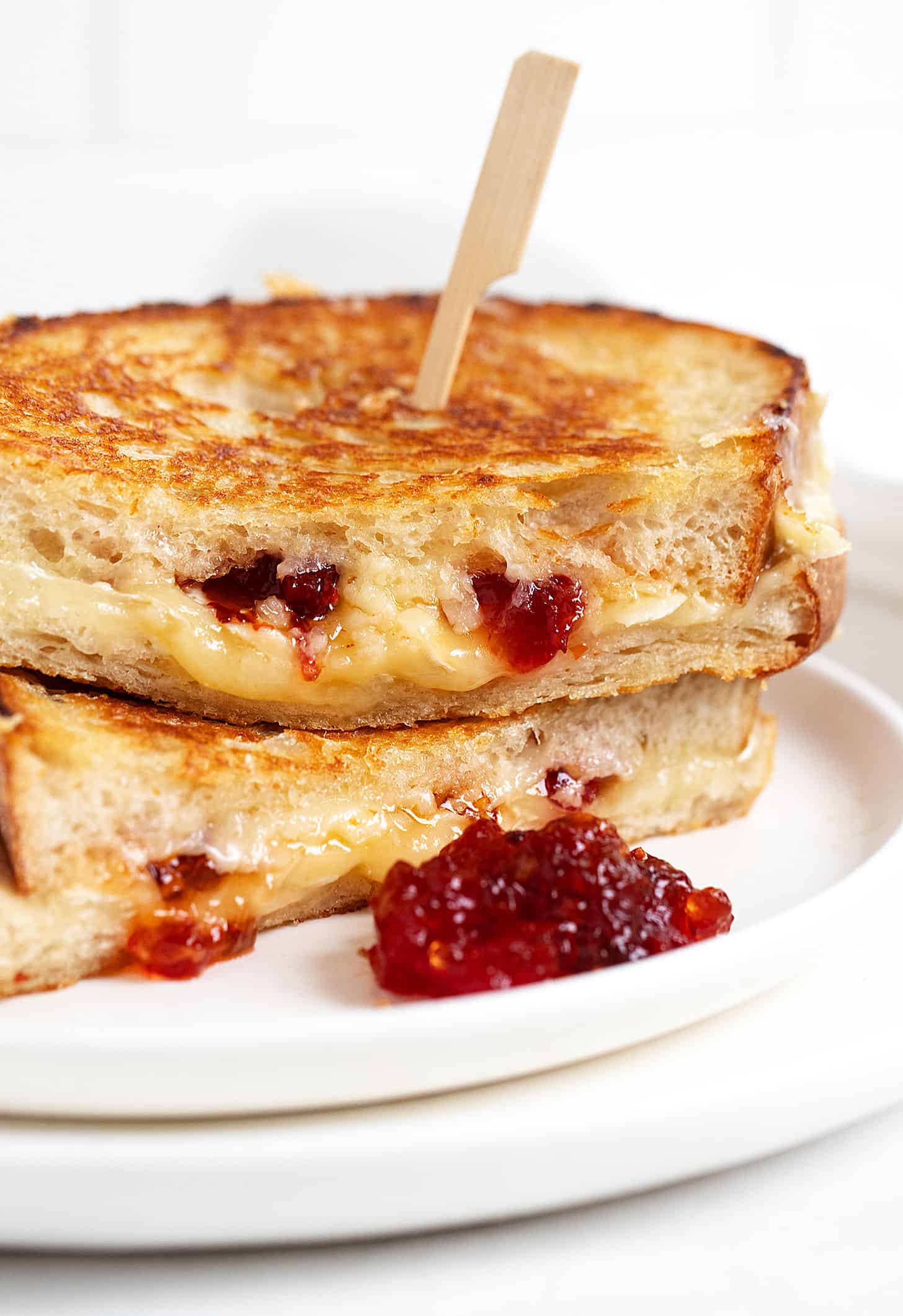 Brie grilled cheese on plate with red pepper jelly