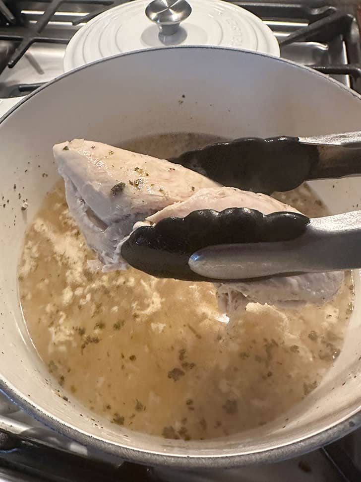 removing cooked chicken breast from broth