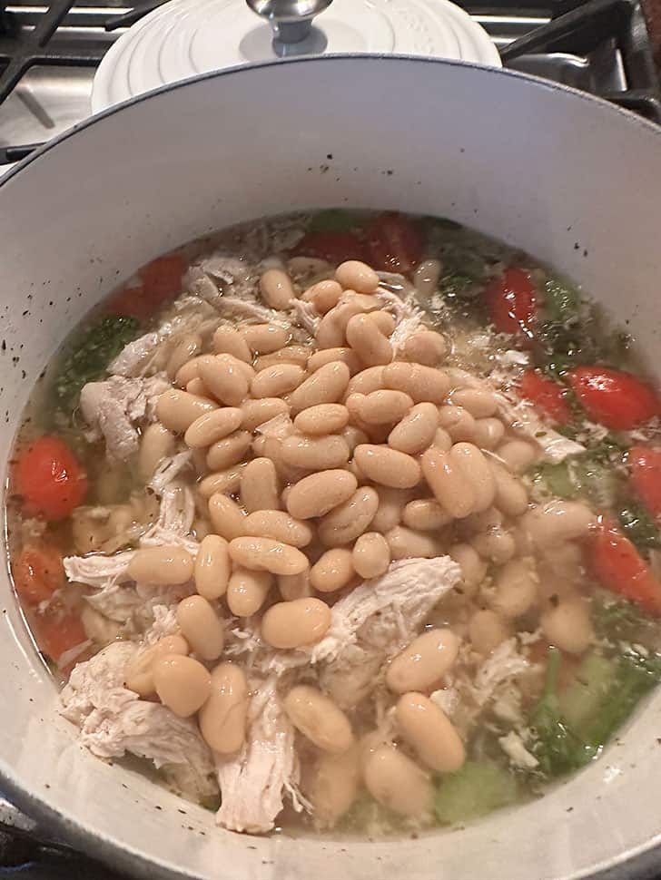 adding white beans to pot