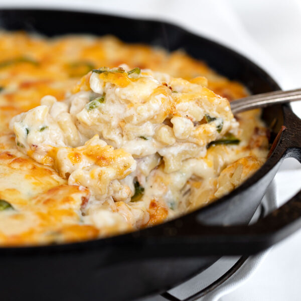 jalapeño mac and cheese in cast iron skillet with spoon