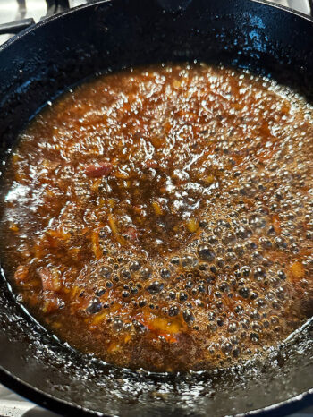 sauce boiling in skillet to thicken
