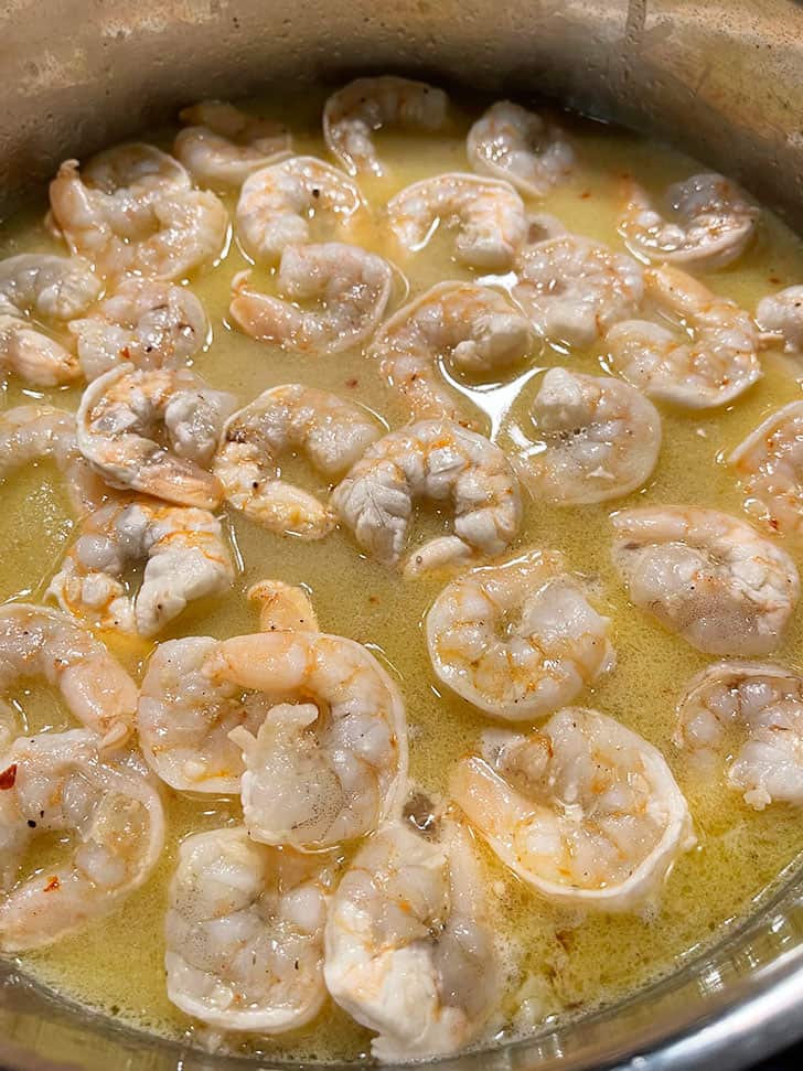 shrimp poaching in wine garlic liquid