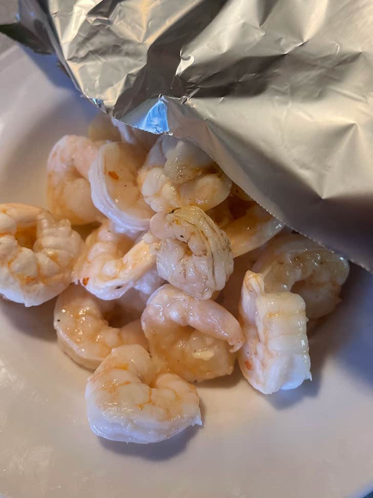 removing cooked shrimp to bowl