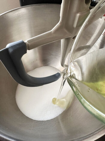 adding oil to sugar in mixer bowl