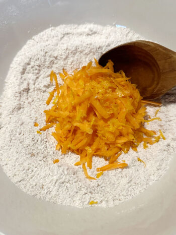 adding shredded carrot to dry ingredients