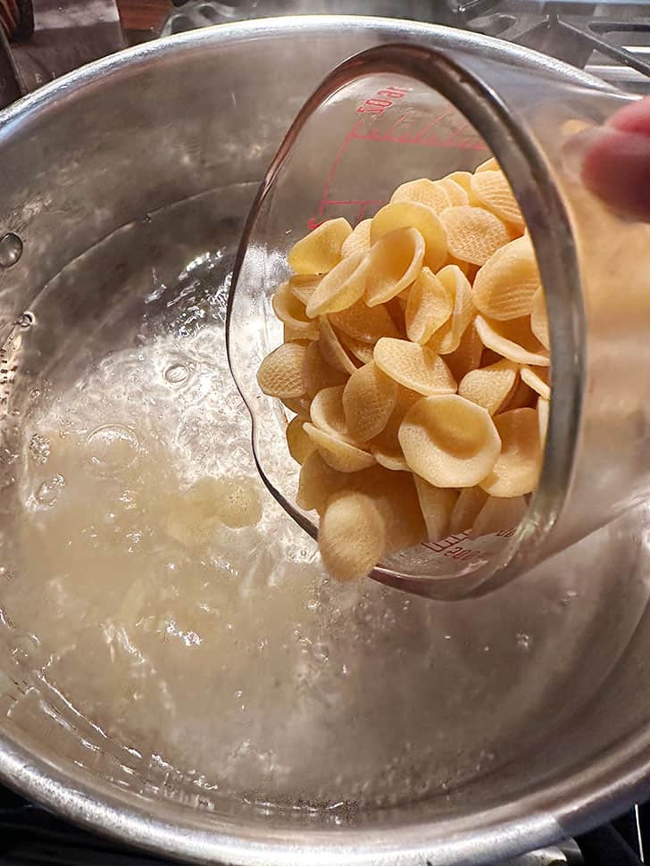adding orecchiette pasta to boiling water