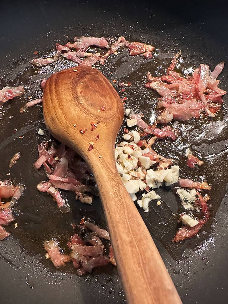 skillet with browned pancetta, garlic and red pepper flakes