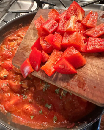 adding red pepper to skillet