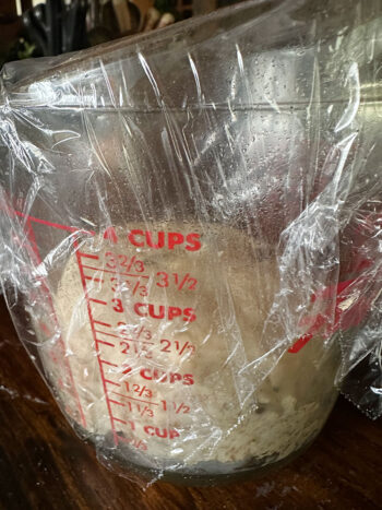 dough rising in measuring cup