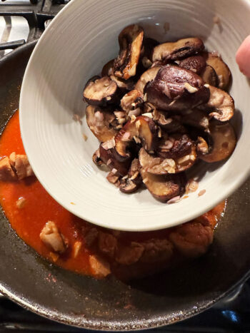 returning mushrooms to pan