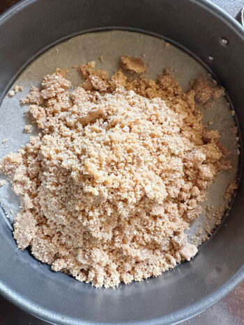 pouring crust mixture into prepared pan