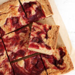 rhubarb blondies cut on parchment paper