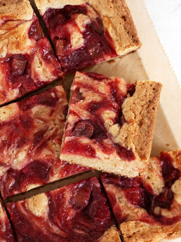 rhubarb blondies cut on parchment paper