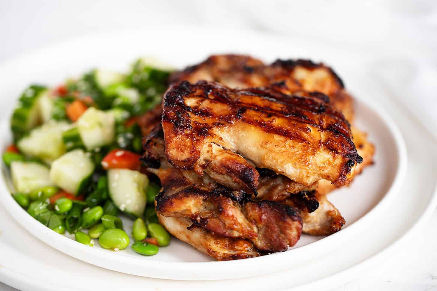 miso chicken on plate with edamame salad
