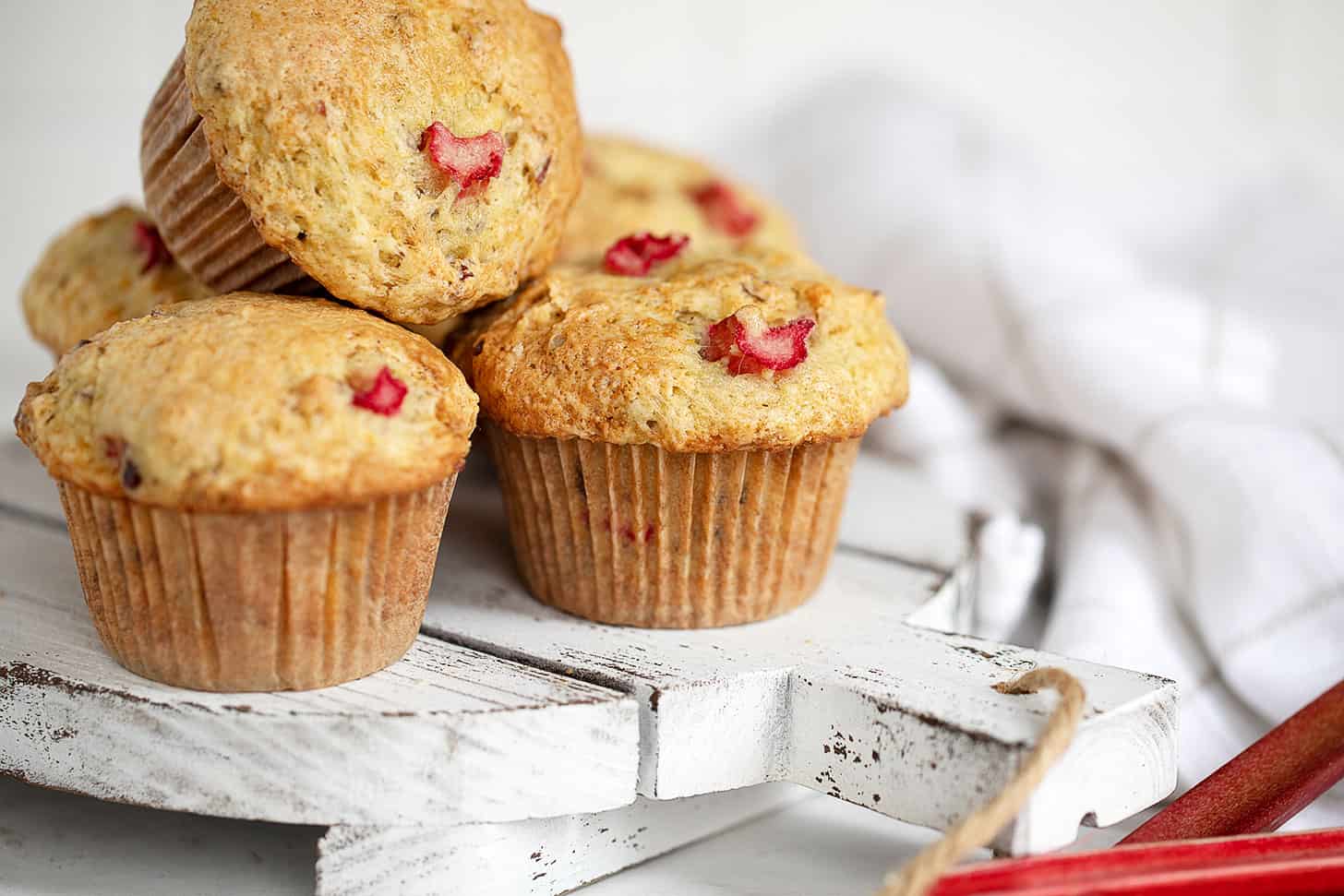 rhubarb muffins on white serving board