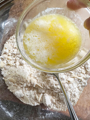 adding melted butter to crumble ingredients
