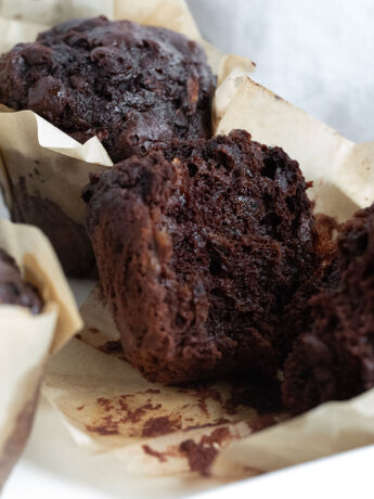 Chocolate zucchini muffins split open.