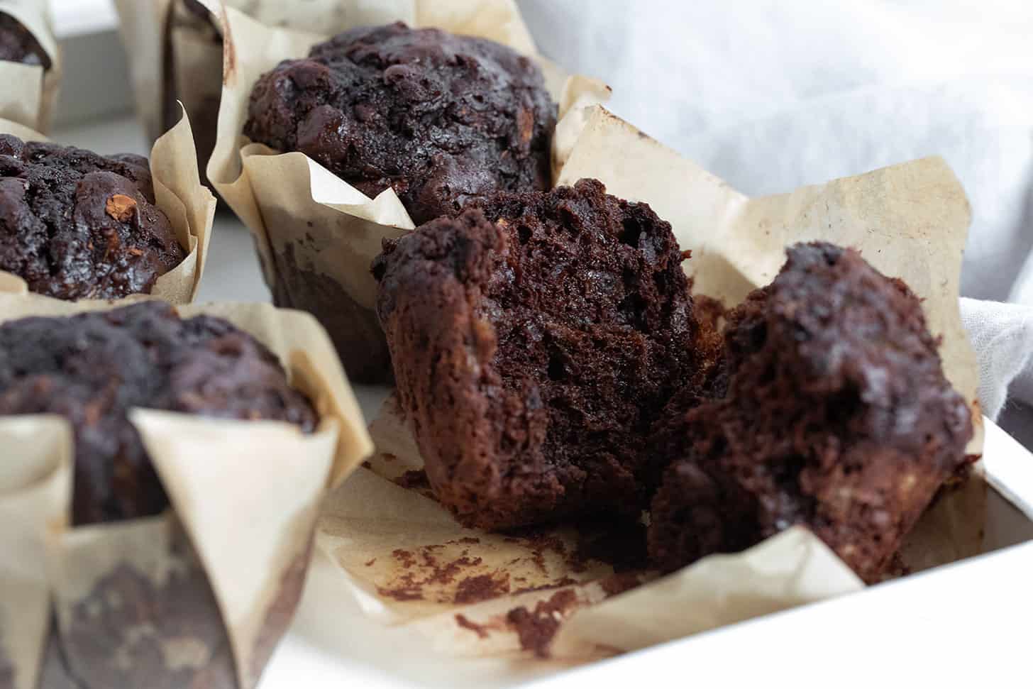 Chocolate zucchini muffins split open.