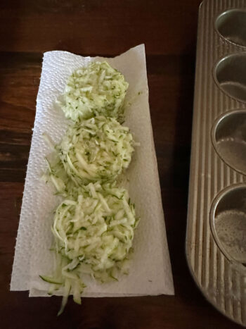 draining shredded zucchini on paper towel