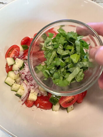 adding fresh herbs to salad