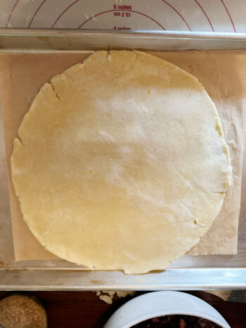 pastry round on parchment on baking sheet