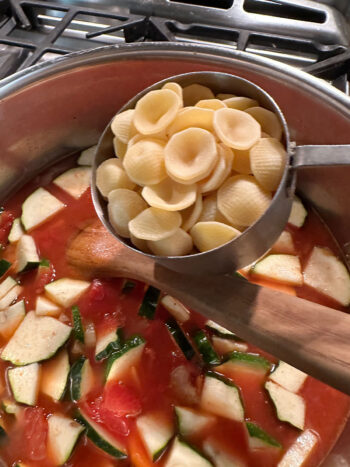 adding orecchiette pasta to soup
