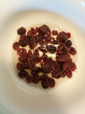 dried cranberries in bowl with cider vinegar