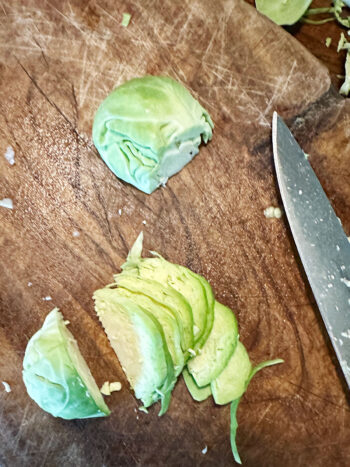 slicing Brussels sprouts on cutting board