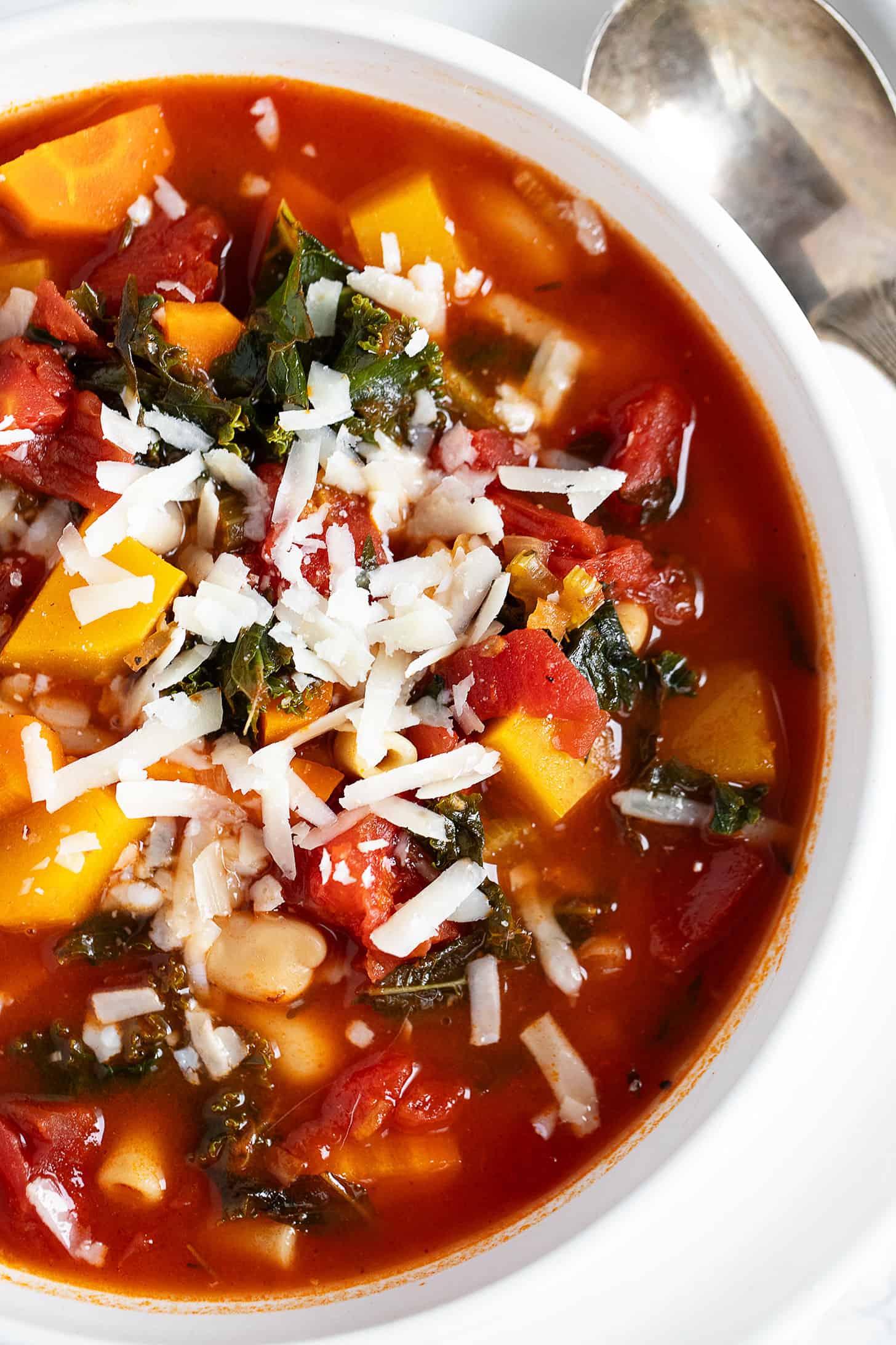 Fall minestrone soup in white bowl.