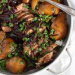 Pork tenderloin with pears and balsamic onions in serving dish.