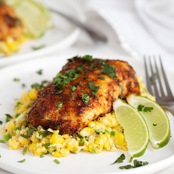 blackened cod on plate with creamed corn