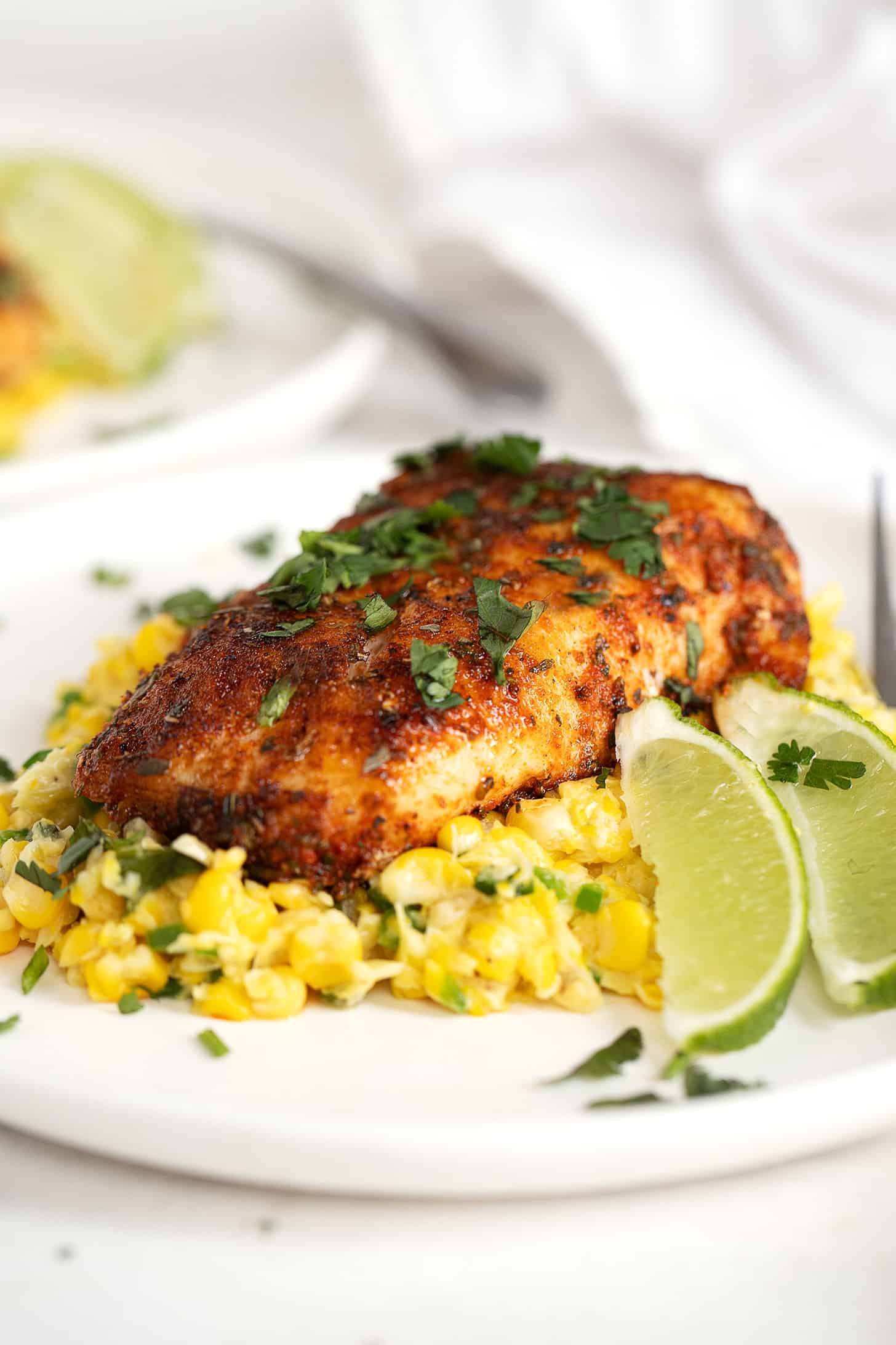 blackened cod on plate with creamed corn